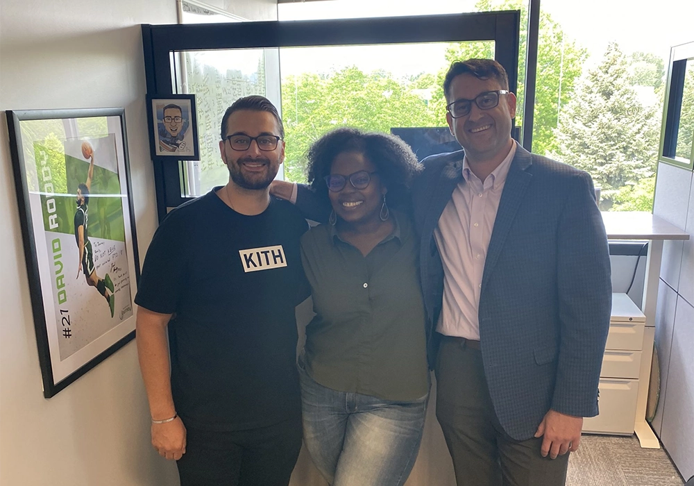 group of people smiling, in an office