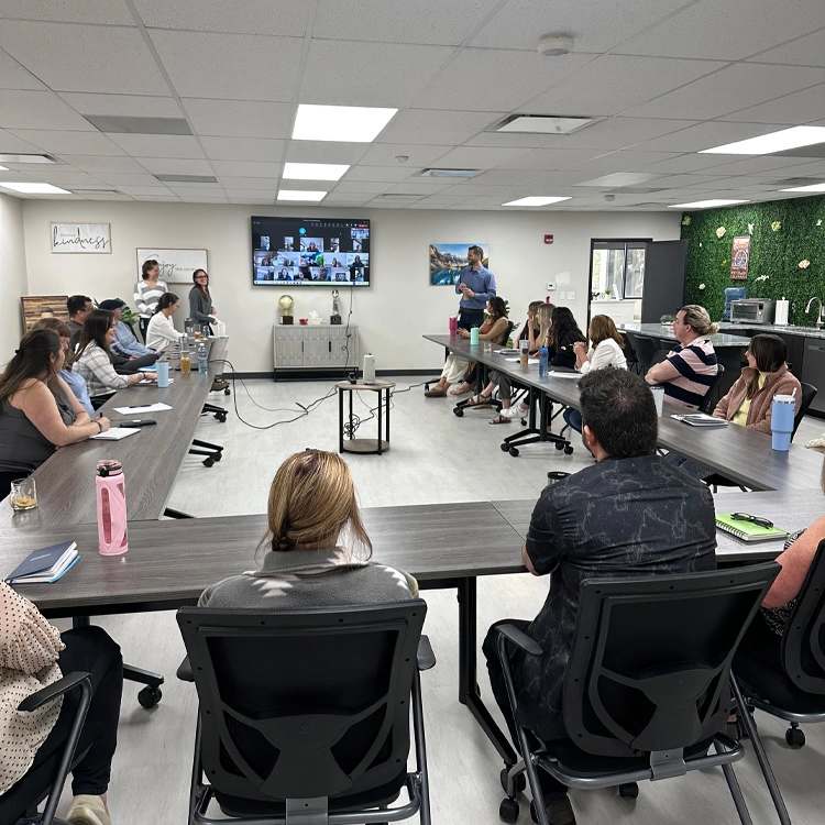 group of people watching presentation in a confererence room