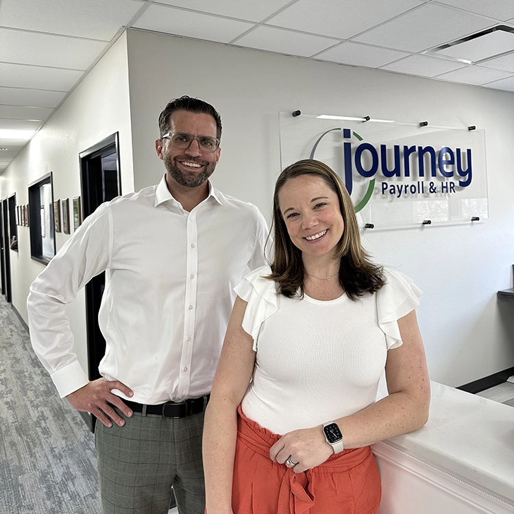 two people smiling at the office