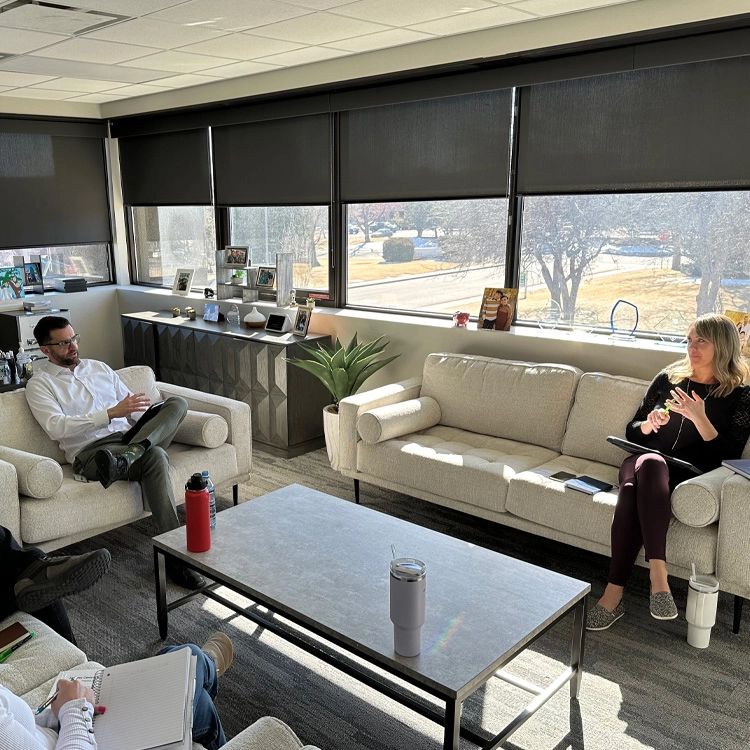 two people working on a couch, in a meeting