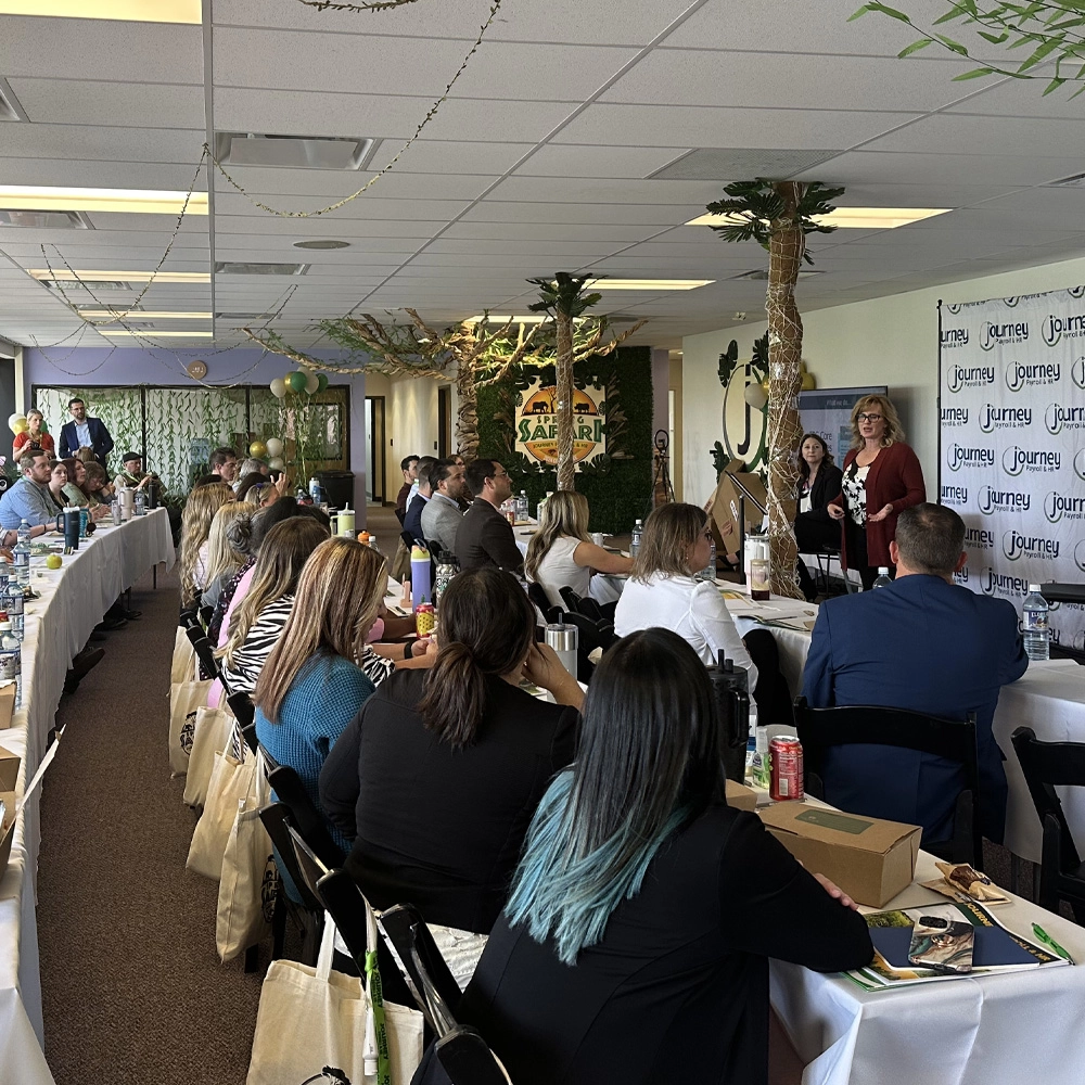 large group of people in a conference room listening to a speaker