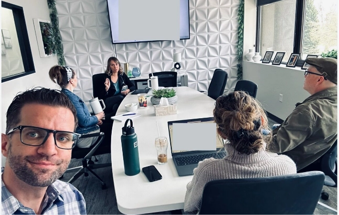 group of people in a conference room, having a meeting