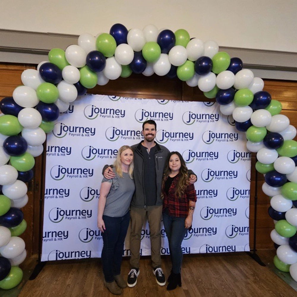 group of people in front of balloon arch