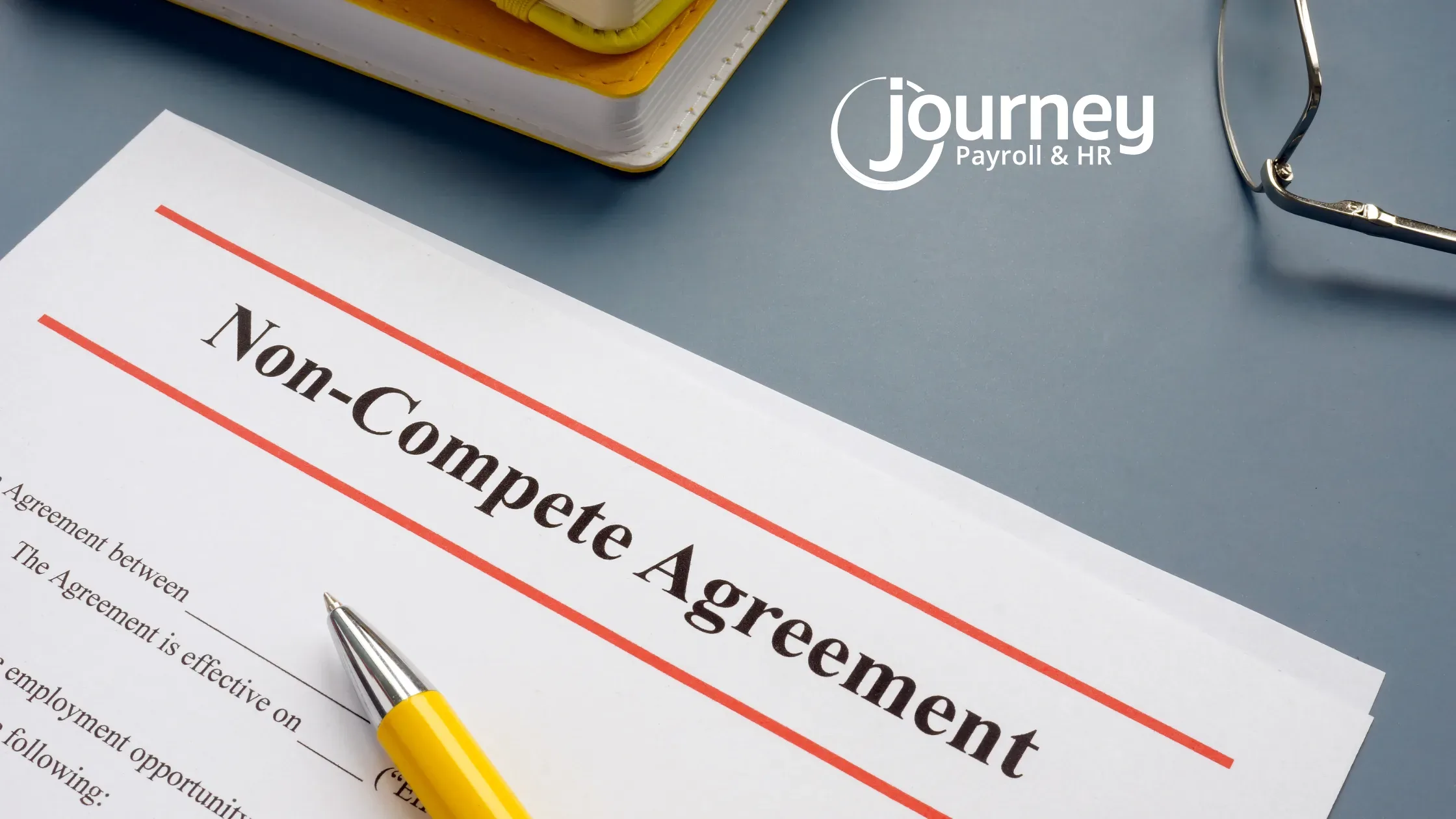 A non-compete agreement document partially visible on a desk next to a yellow pen. Glasses and a closed notebook are nearby. The logo "Journey Payroll & HR" is displayed on the top right corner against a blue background.